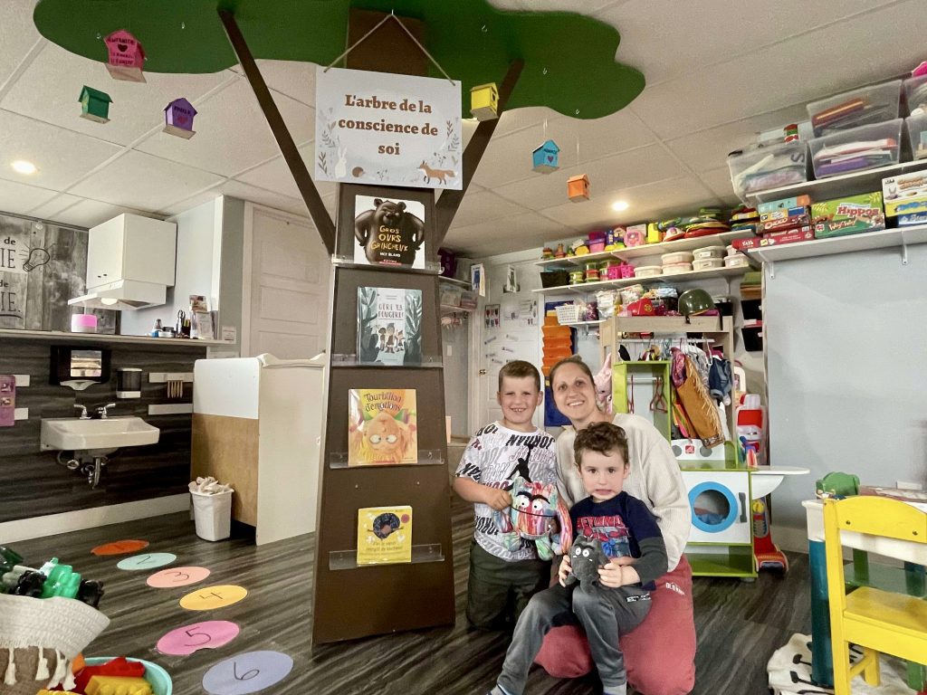 Joanie Lepage, en compagnie de deux enfants de son service de garde (Garderie chez Nini), devant L’arbre de la conscience de soi.
